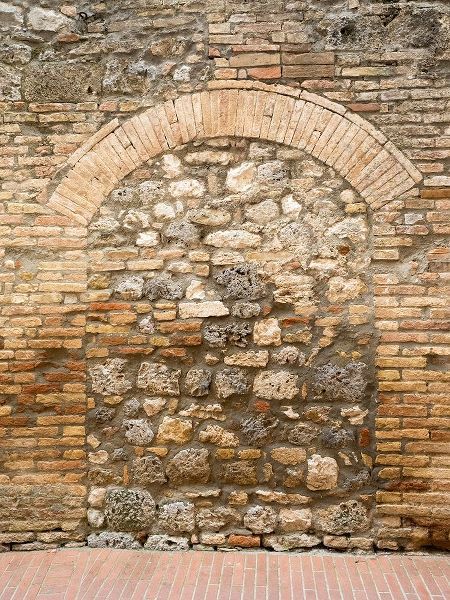 Italy-Chianti Old doorway that has been closed off with stone in the town of San Gimignano